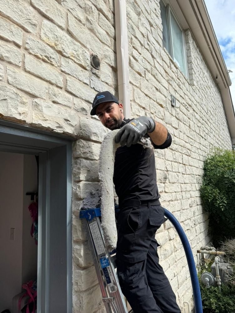 Austin Breeze technician holding debris removed from a home