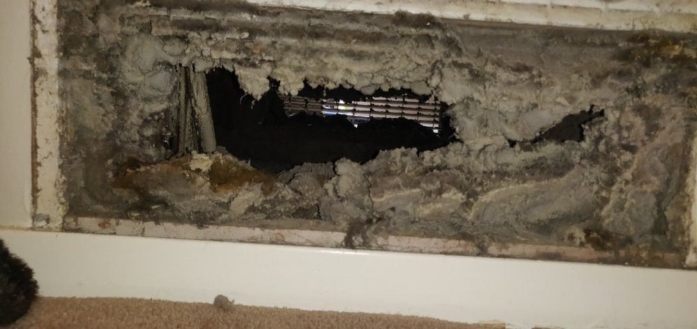 A clogged return vent packed with lint and dust